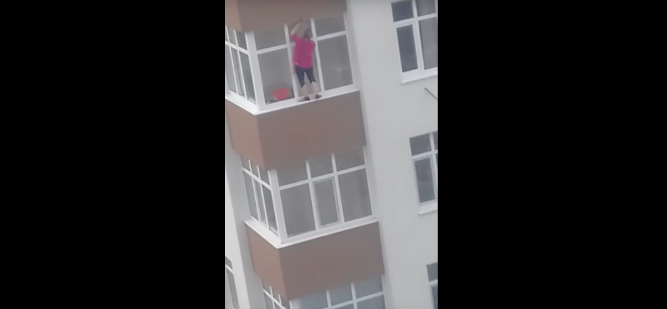 Bold Woman Balances on a 5th Floor Ledge to Clean Windows [WATCH]