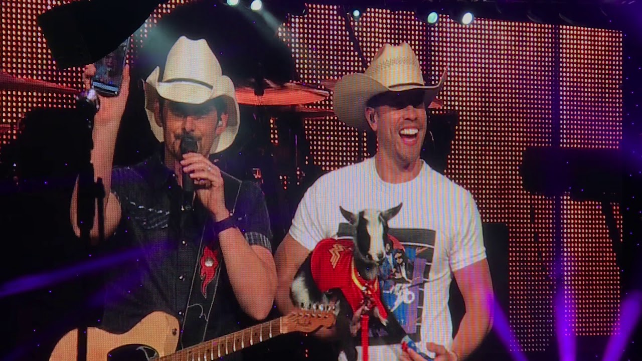 Brad Paisley reacts to Dustin Lynch giving him a goat.