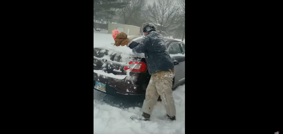 Dad Uses His Child to Clear Snow Off His Car and the Kid Loves It [WATCH]
