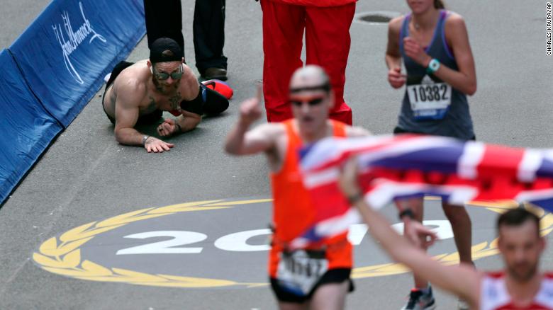 Marine Crawls Across Finish Line at the Boston Marathon in Honor of Fallen Soldiers