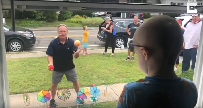 Three Year Old Child Fighting Cancer Cannot Go Outside – So People are Entertaining Him Through His Front Window [WATCH]